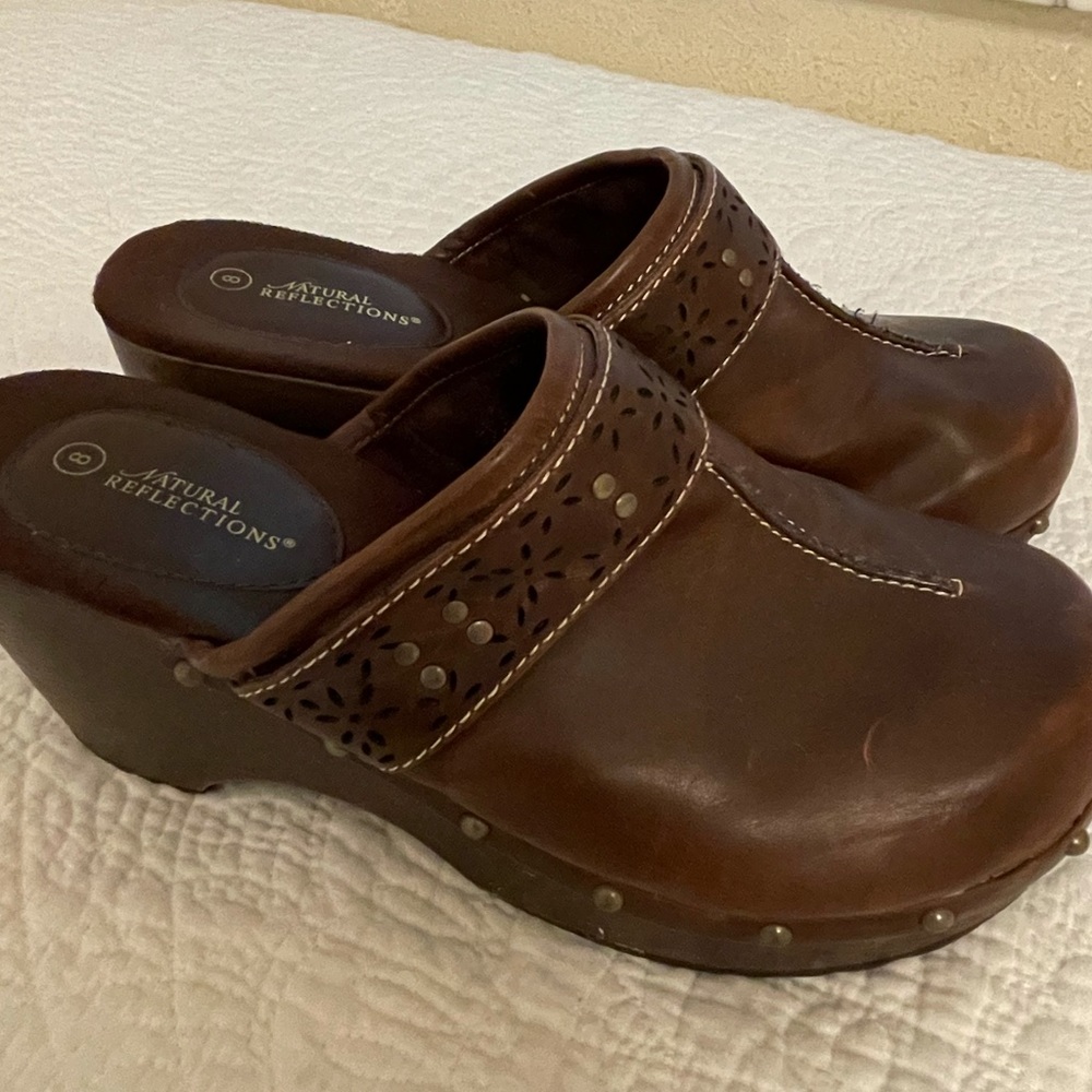 Lightly worn brown leather clogs